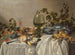 Śniadanie lub srebrne i szklane naczynia na nakrytym stole z winoroślami, owocami i wypiekami - Pieter Claesz — widok dzieła