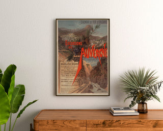 Plakat vintage Auvergne, wycieczki Orléans, oprawiony nad drewnianą komodą, między roślinami.