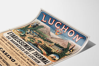 Wintage plakat Bagnères-de-Luchon, uzdrowisko, pokazany na lekko zagiętej kartce, widok w perspektywie.