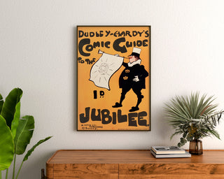 Plakat vintage Dudley Hardy, comic guide, oprawiony nad drewnianą komodą, między roślinami.