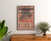 Plakat vintage Fort-de-France, festyn dobroczynny, w ramie nad drewnianą komodą, między roślinami.